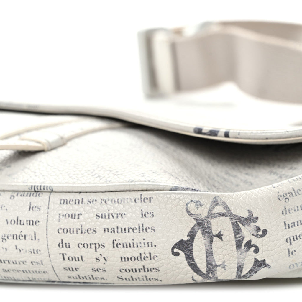 X Daniel Arsham Grained Calfskin Newspaper Print Saddle Bag White AT My store