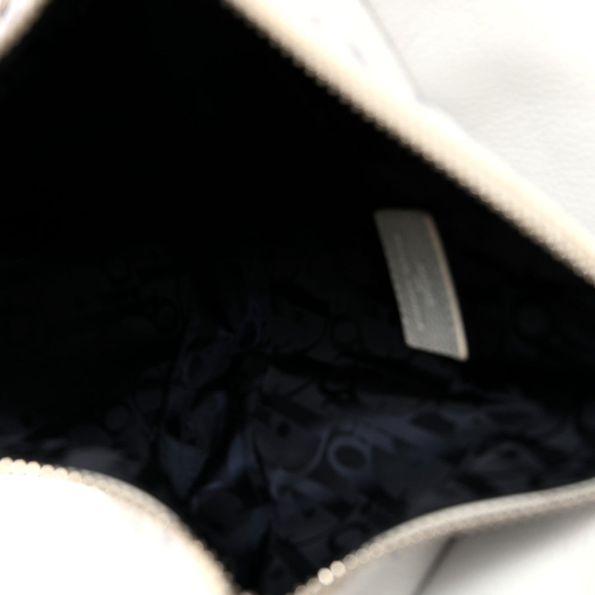 X Daniel Arsham Grained Calfskin Newspaper Print Saddle Bag White AT My store